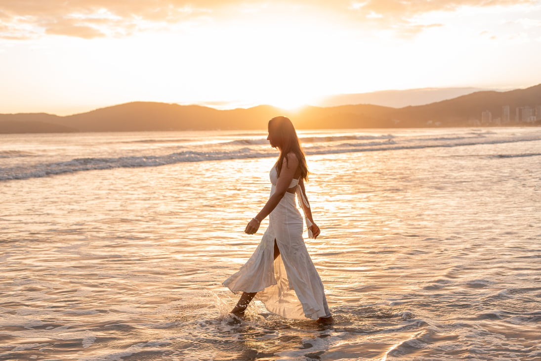 Woman Walking towards the Waters of the Sea